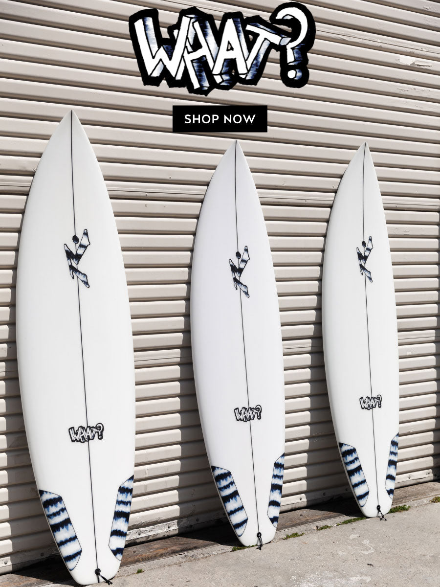 What surfboard models laid against a garage - Rusty Surfboards - Mobile