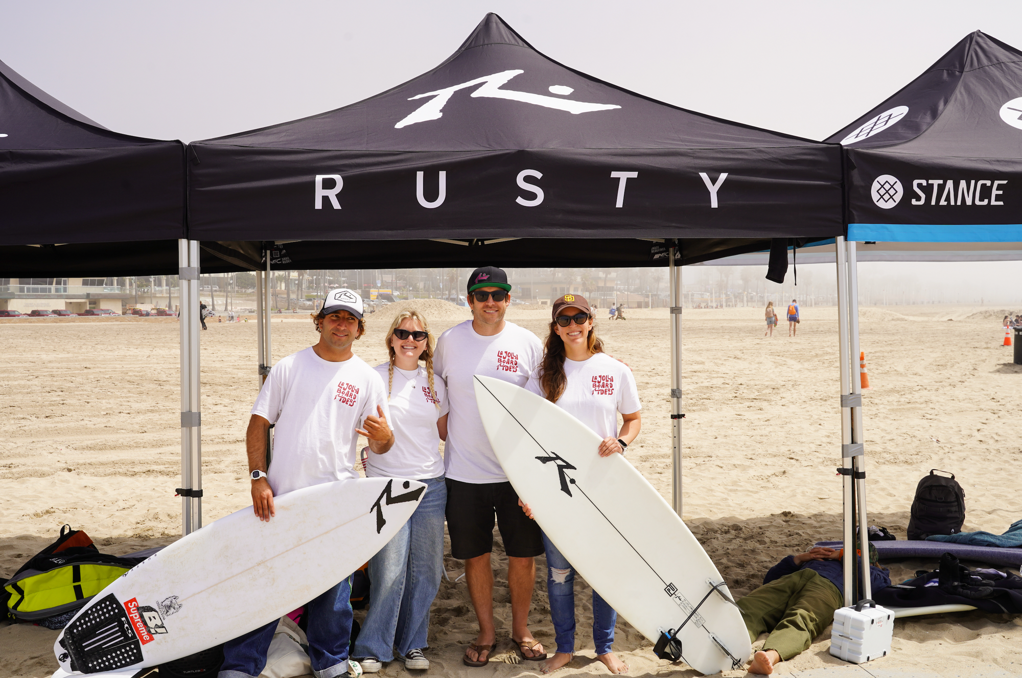 Picture of Rusty surfboards team with Jacob Szekely and Tiare Thompson at the Battle of the board riders 2024 - La Jolla Board Riders Club - Huntington Beach